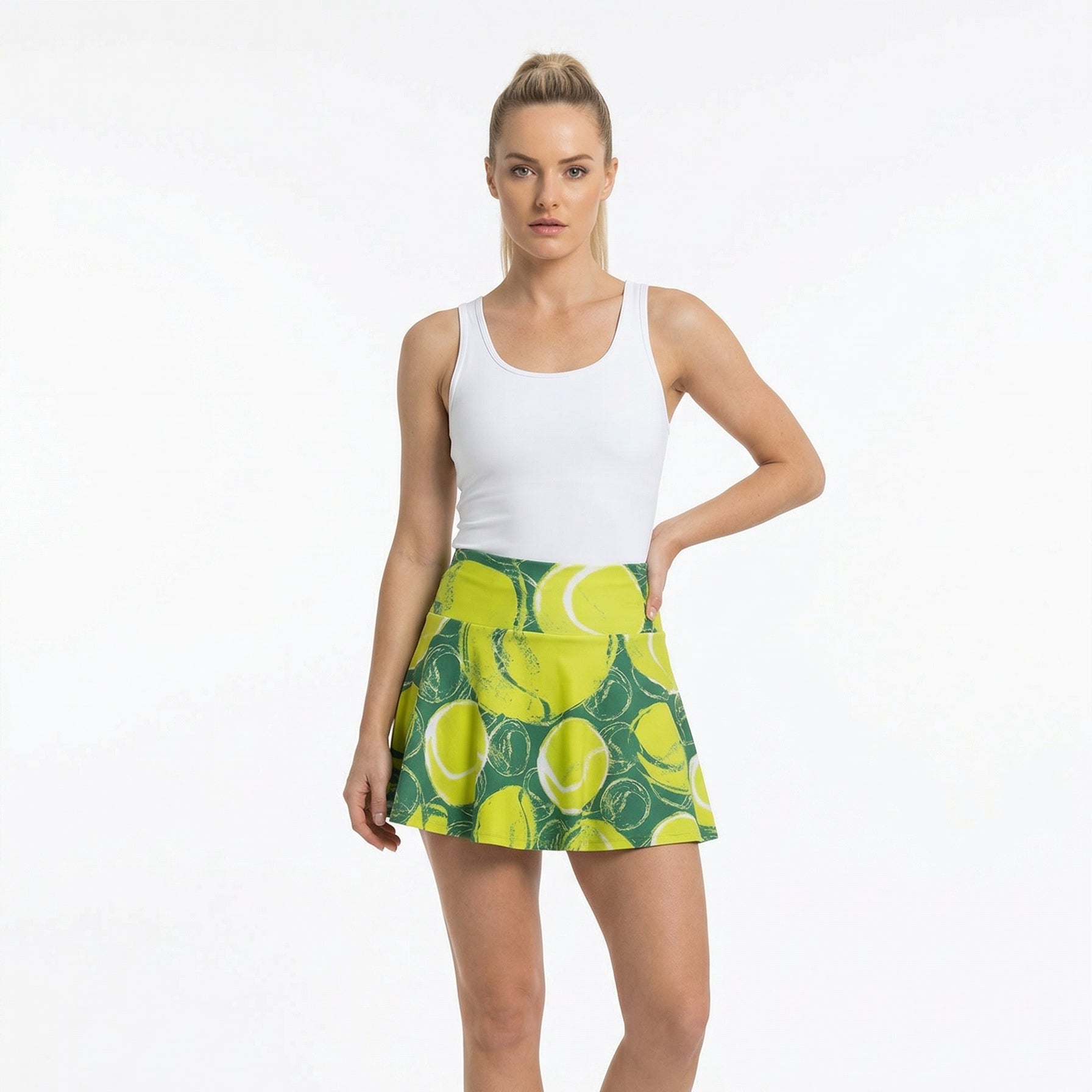 Woman wearing a white tank top and green tennis skirt with lemon pattern on a white background