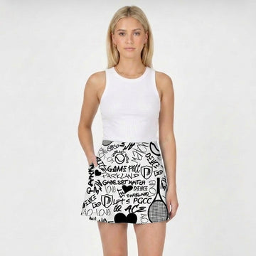 Woman wearing a white sleeveless top and a black and white tennis-themed skirt on a white background