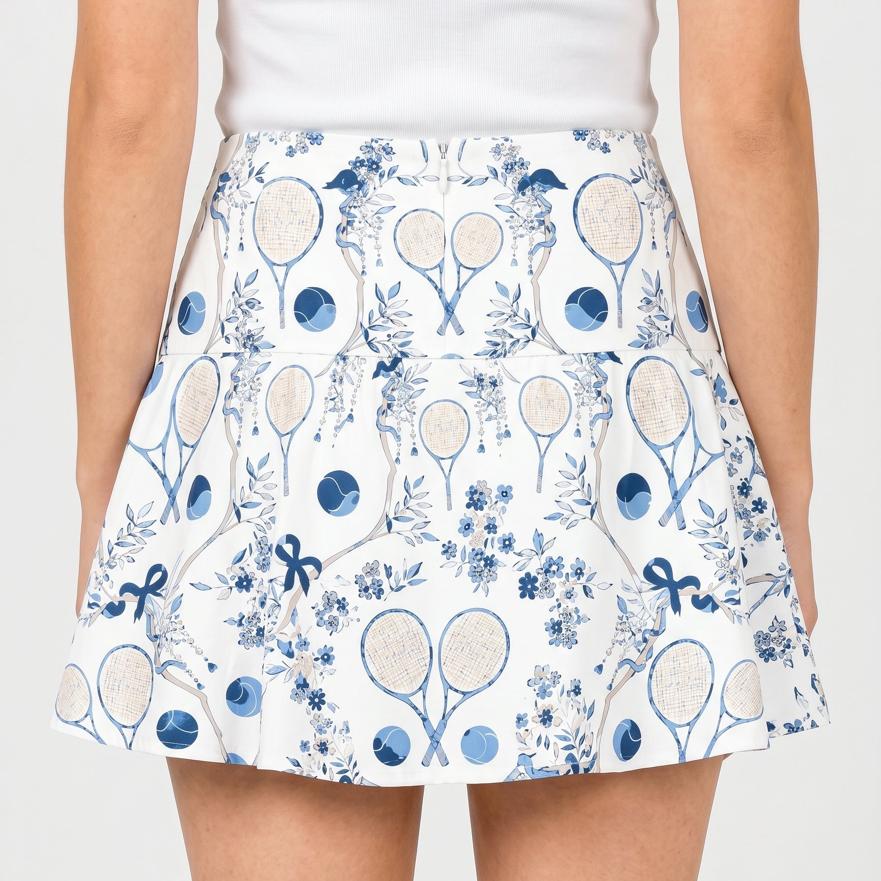 Skirt with tennis racket and floral pattern on a white background