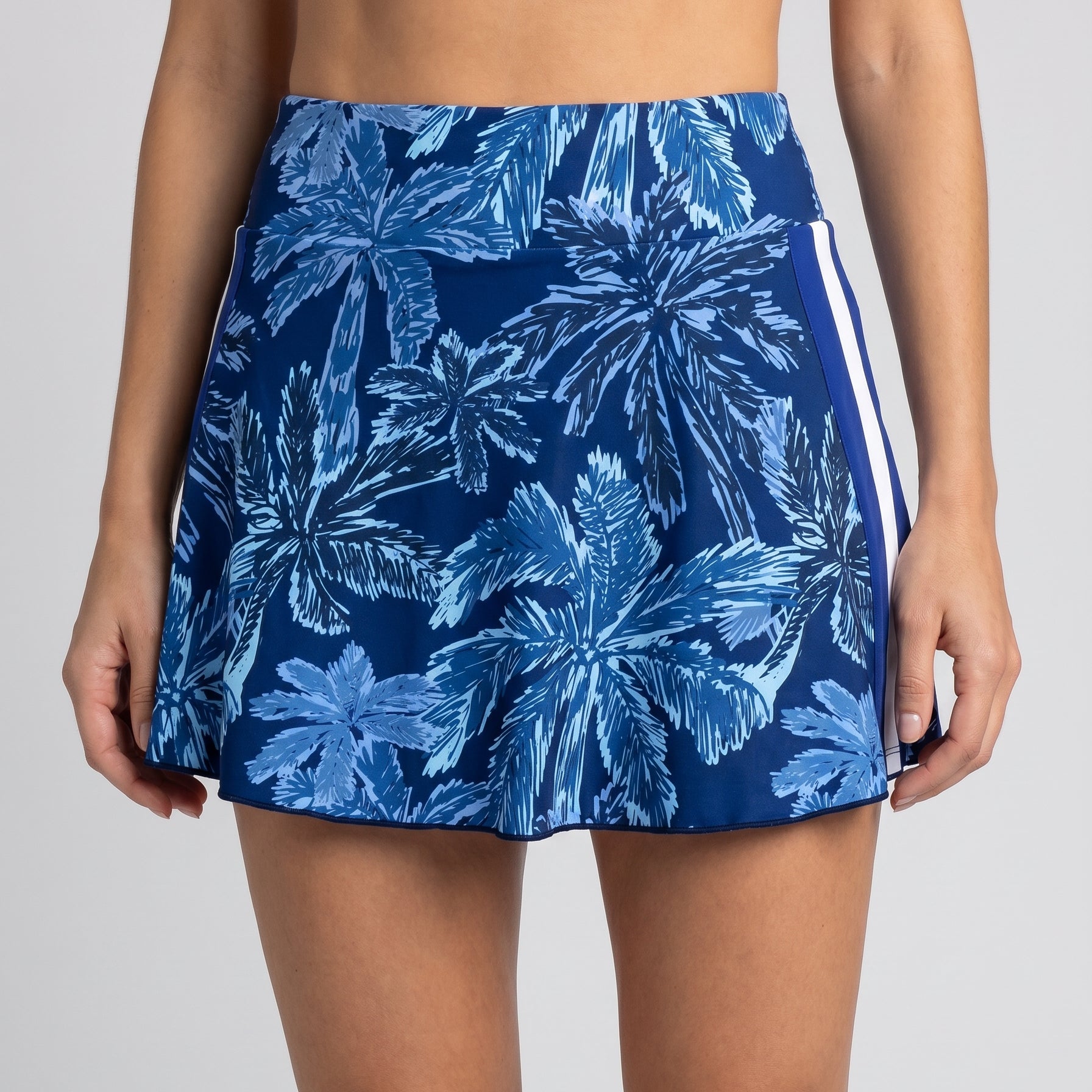 Blue floral skirt worn by a person on a plain background