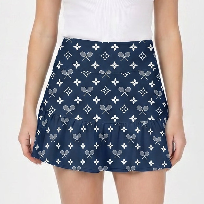 Woman wearing a white tank top and navy patterned skirt on a white background